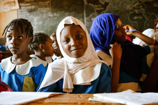 young schoolgirl wearing sitting attentively in a classroom in Nigeria