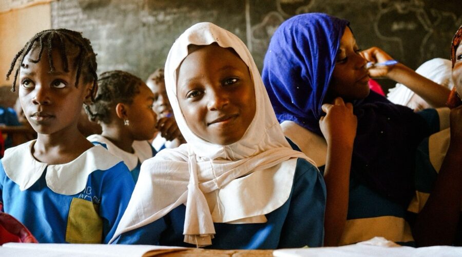 young schoolgirl wearing sitting attentively in a classroom in Nigeria